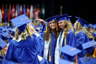 Two students taking a picture at Commencement