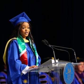 Esther Ndashaala speaking at graduation